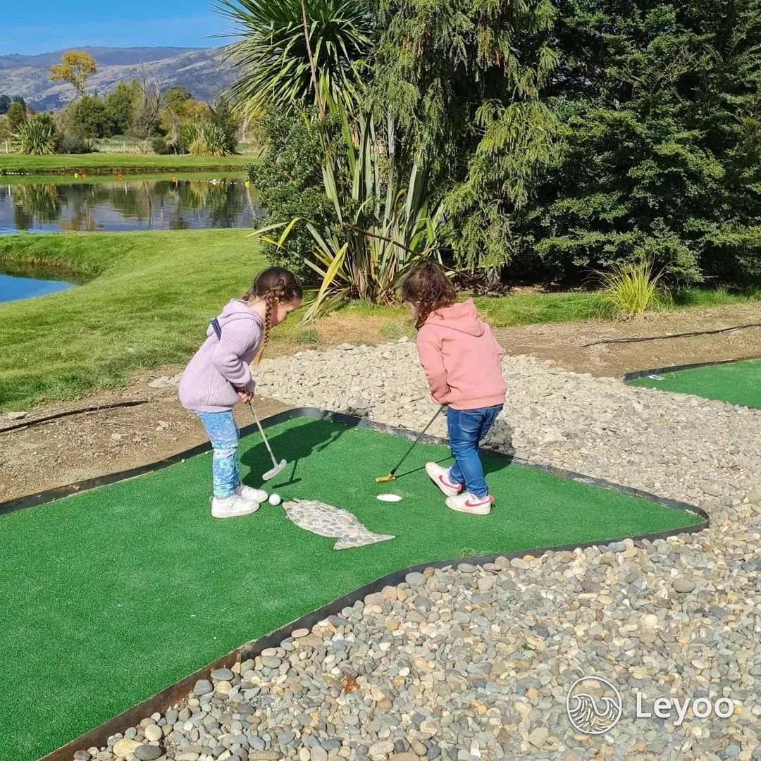 Two children playing outdoor mini golf in Wanaka